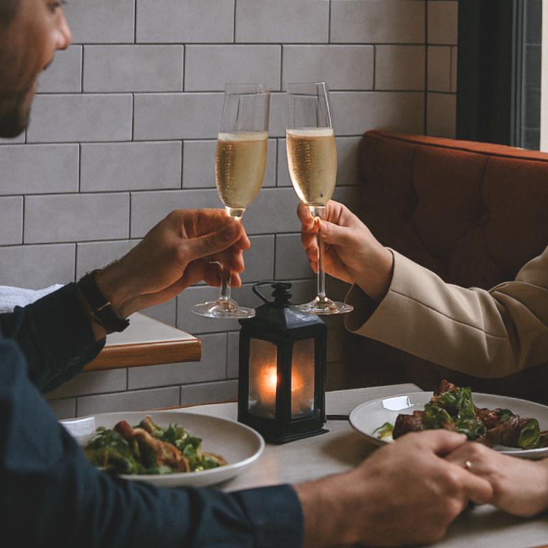 Two people cheersing with Champagne